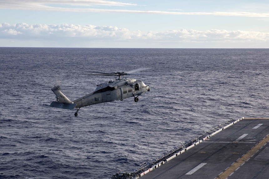 An MH-60s Sea Hawk Helicopter, assigned to Helicopter Sea Combat Squadron (HSC) 28, prepares to land on the flight deck of the amphibious assault ship USS Bataan (LHD 5), Dec. 24, 2019. - KAITLIN ROWELL (U.S. NAVY)