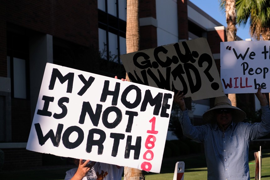 Protesters on Tuesday march down Camelback Road to the main entrance of Grand Canyon University. - KATYA SCHWENK