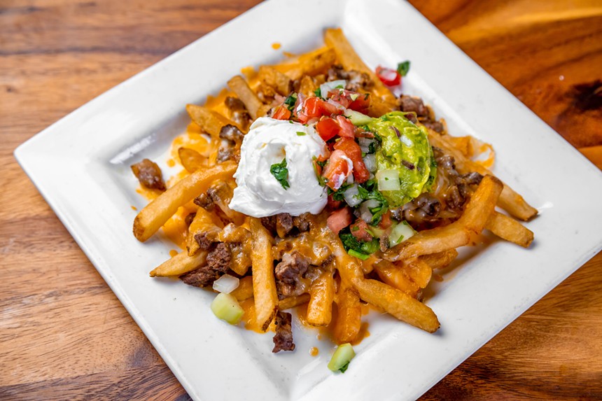 Macayo's carne asada fries come topped with mixed cheese, sour cream, guacamole, and pico de gallo. - MMT FOOD PHOTOGRAPHY