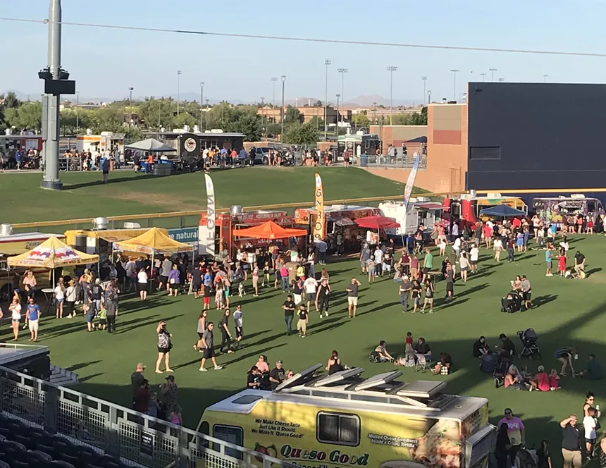 Food trucks in a field.