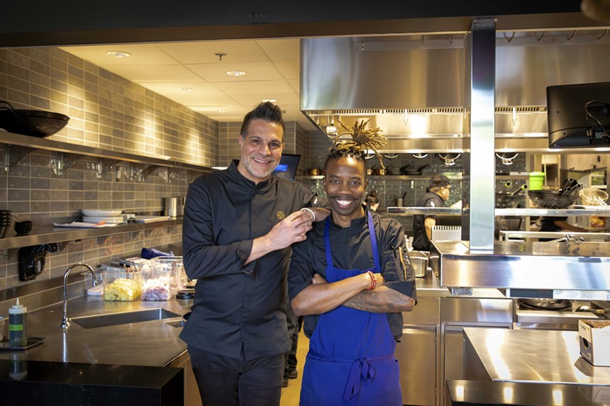 Chefs Angelo Sosa and Ed Harris pose in the kitchen.