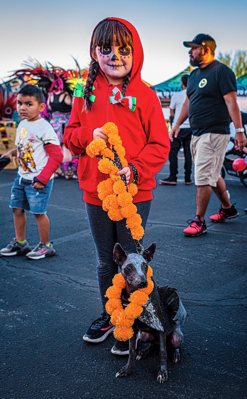 Girl with dog at Dia de los Muertos festival