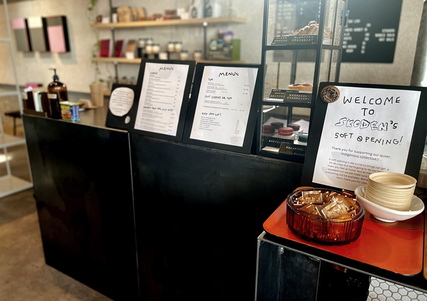 A view of the counter at Skoden Coffee & Tea, including the menu and the pastry case.