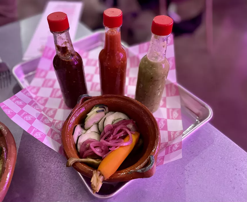 A bowl of pickled vegetables and hot sauces at Huarachis.
