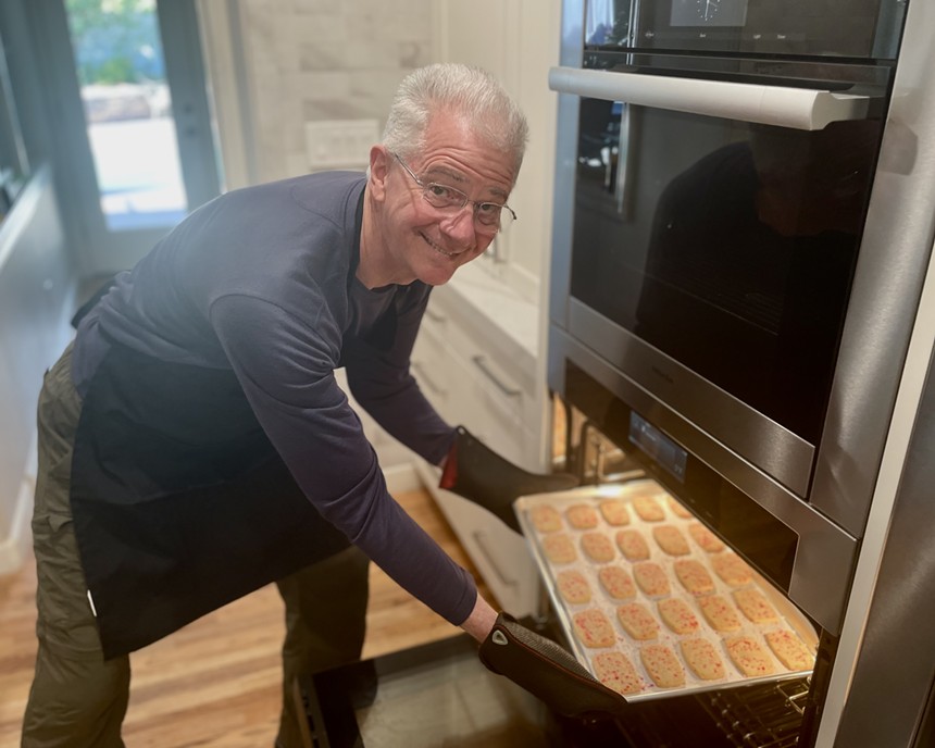 Art Rowland takes cookies out of the oven.