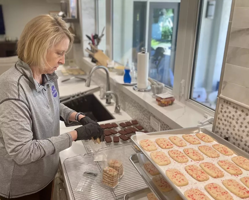 Kathy Rowland packages cookies.