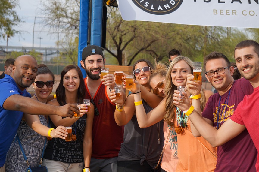 A group poses with beer samples at the Strong Beer Festival.