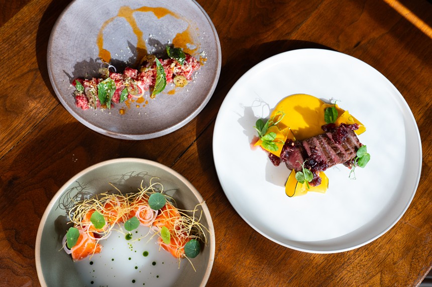 Three plates of food feature signature dishes at Uchi.