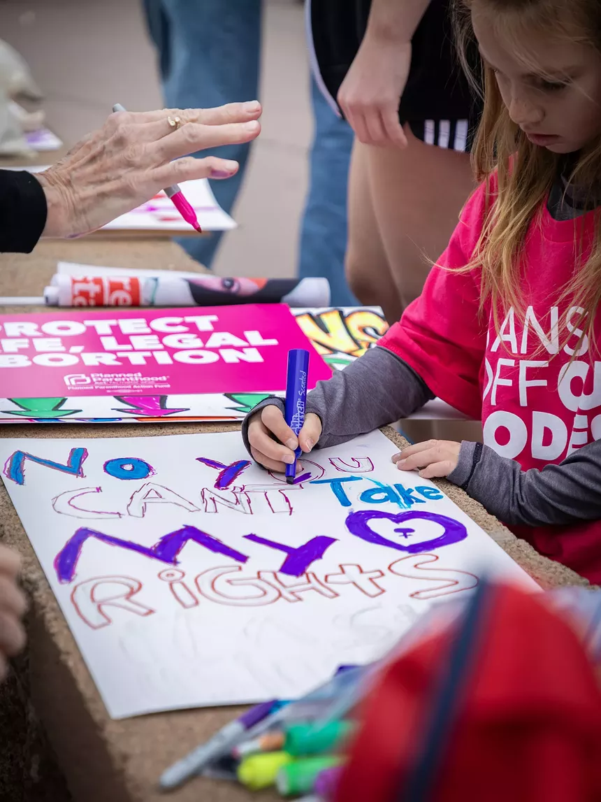 young activist makes a protest sign