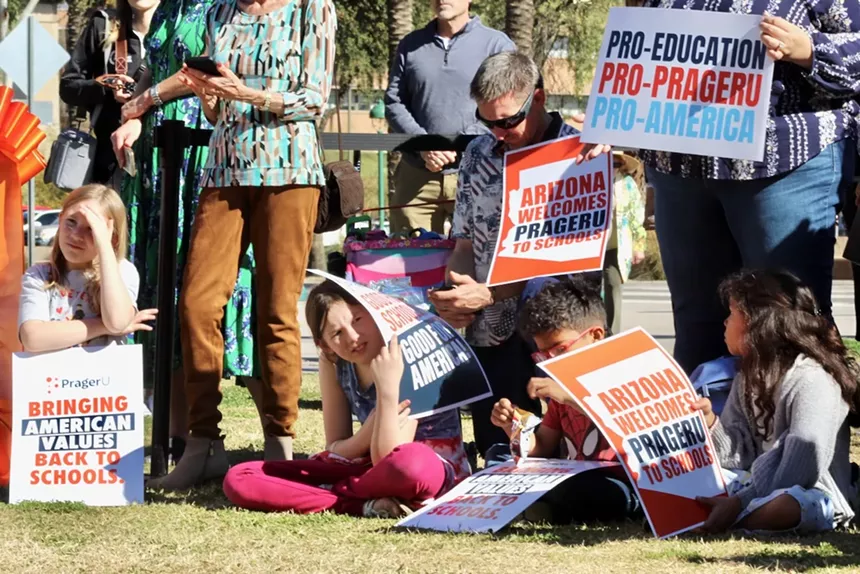 Children holding poster board signs