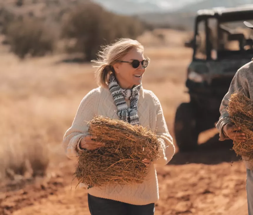 Lisa Khan holds hay.