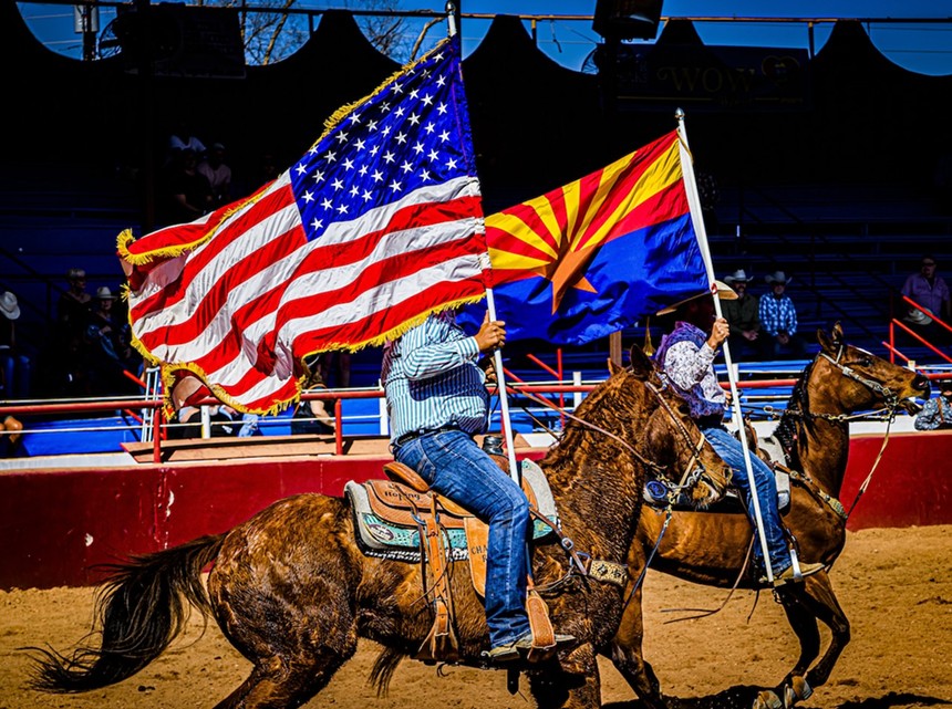 Cowboys on horseback with flags