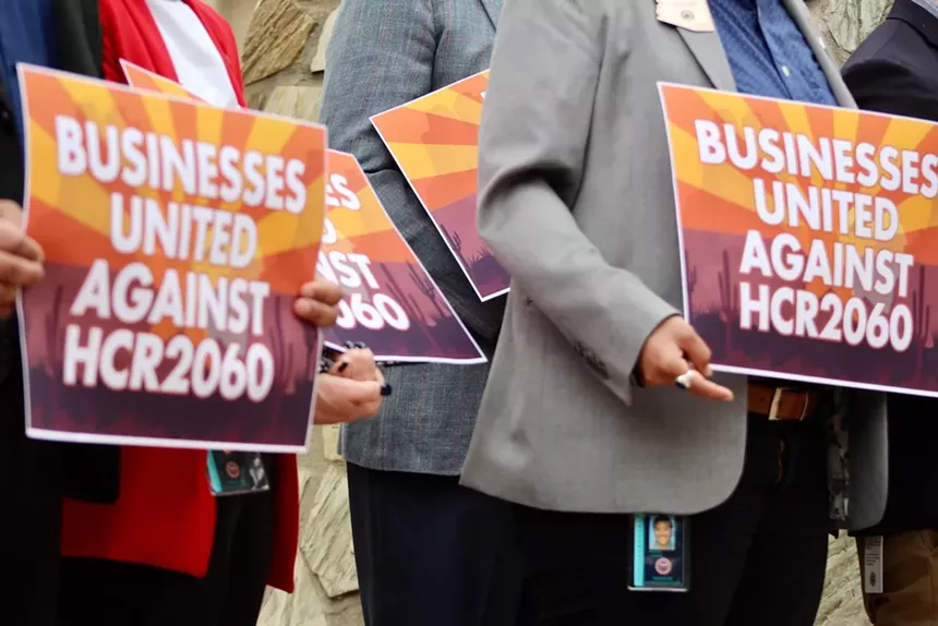Hands and arms and bodies hold signs.