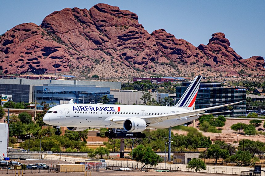 An Air France flight descends for landing in front of a desert mountain in Phoenix.