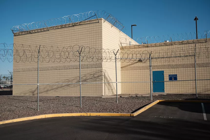 The exterior of Estrella Jail, with barbed wire fences surrounding it.