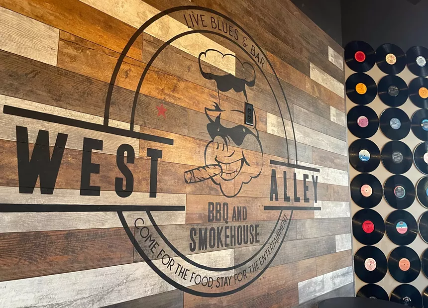 Entryway sign at West Alley BBQ and Smokehouse.