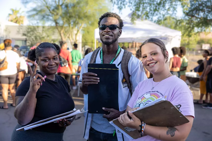 Three people with clipboards.