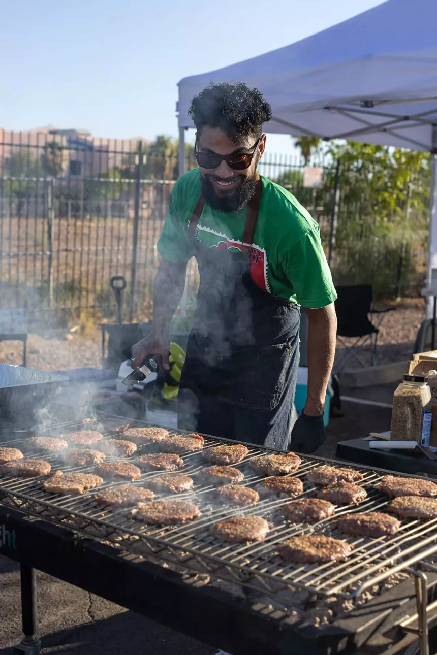 A man cooking on an outdoor grill.
