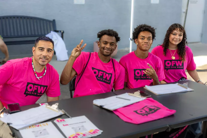 Four people in pink T-shirts.
