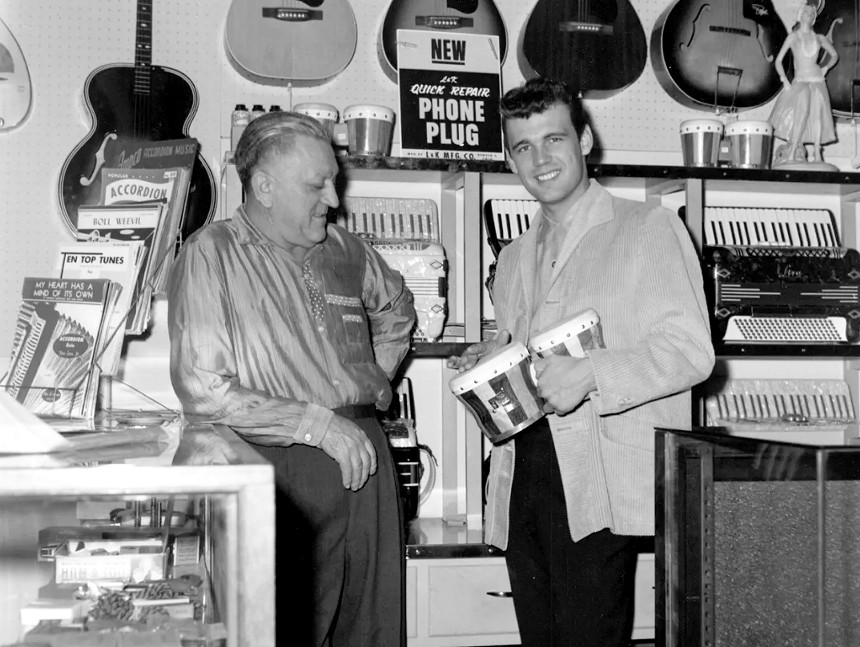 A vintage photo of two men in a store.