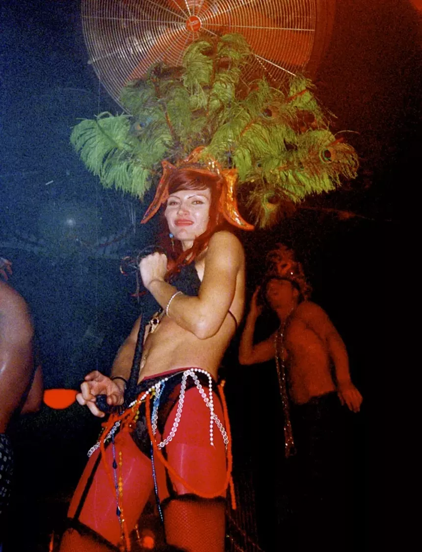 A smiling club patron wearing a costume.