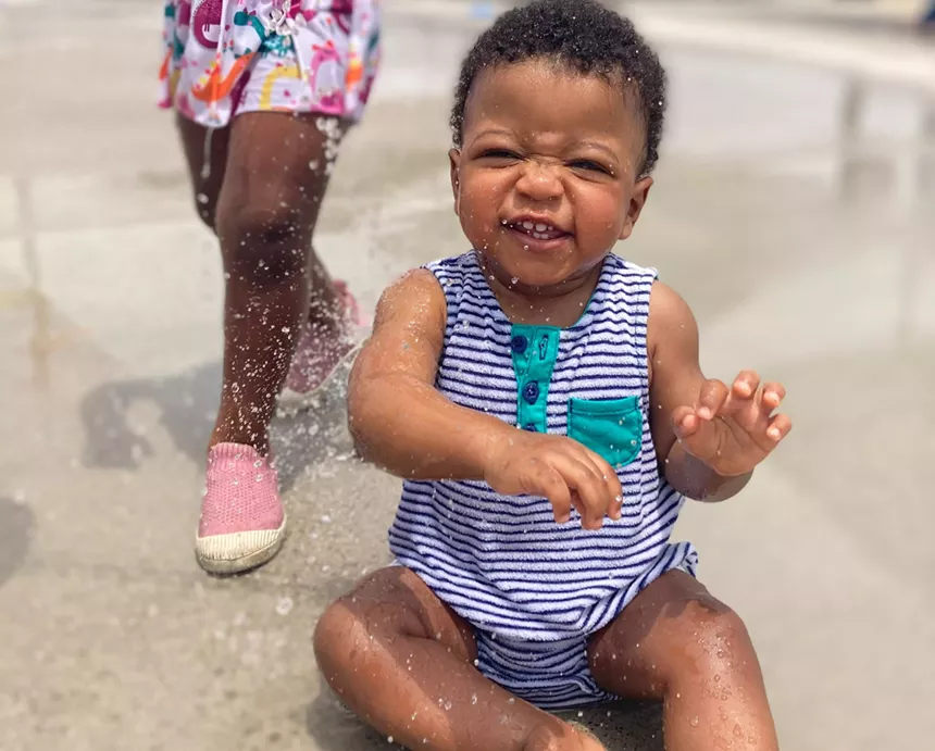 A baby at a splash pad