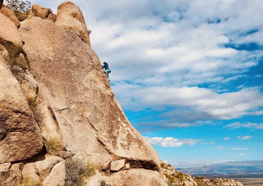 A woman rock-climbing.