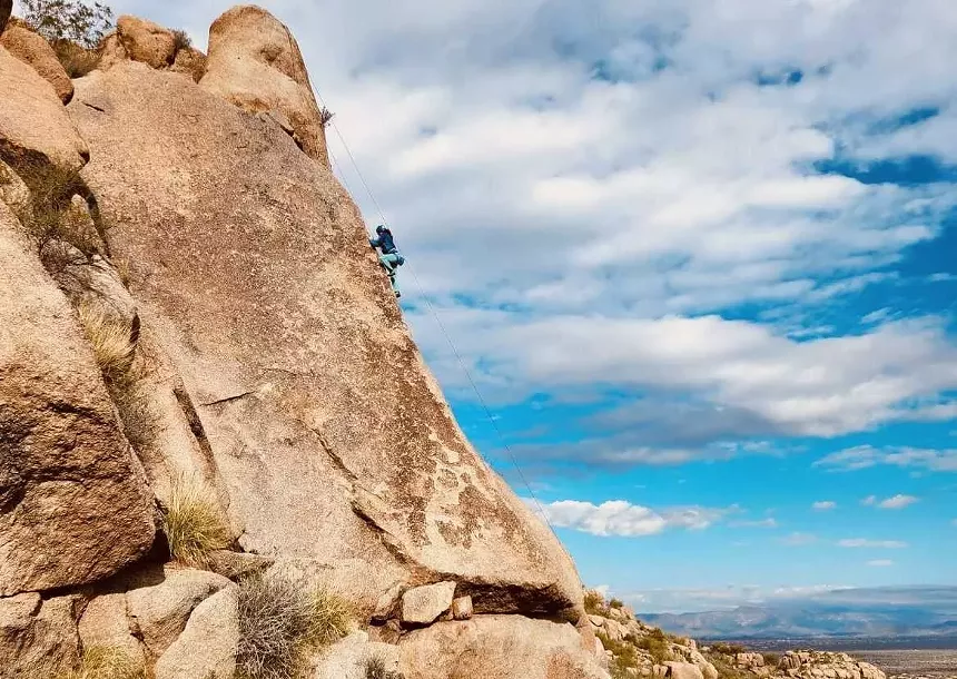 A woman rock-climbing.