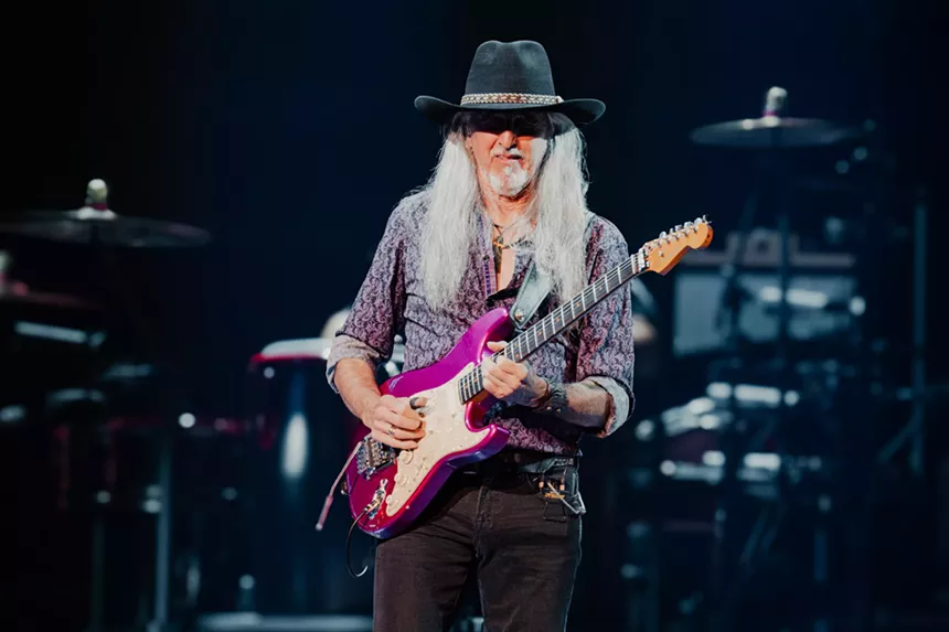 A man playing a guitar.