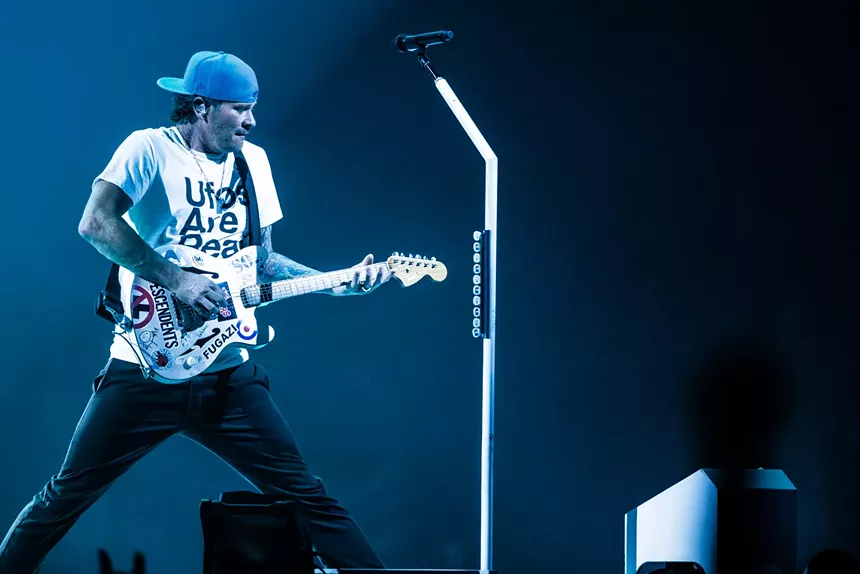 A man playing guitar.