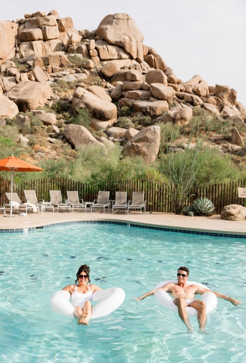 A man and a woman at a hotel pool.