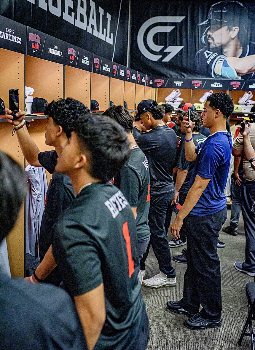 A locker room full of high school baseball players check out what's in their lockers
