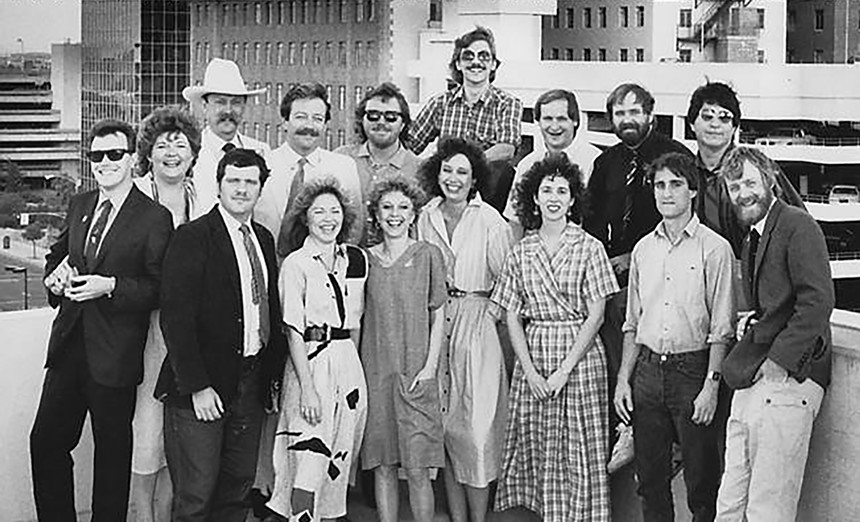 A black and white photo of a group of white people.