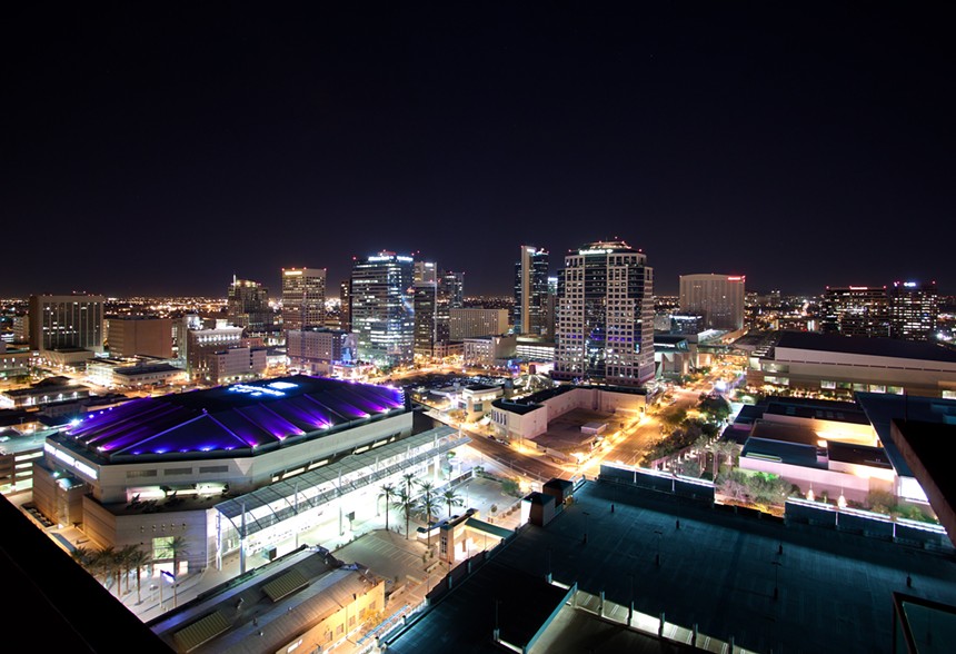 a nighttime photo of downtown Phoenix in 2012, featuring the Suns arena and Bank of America Tower.