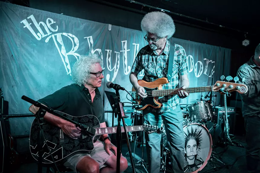 Two guitarists performing.