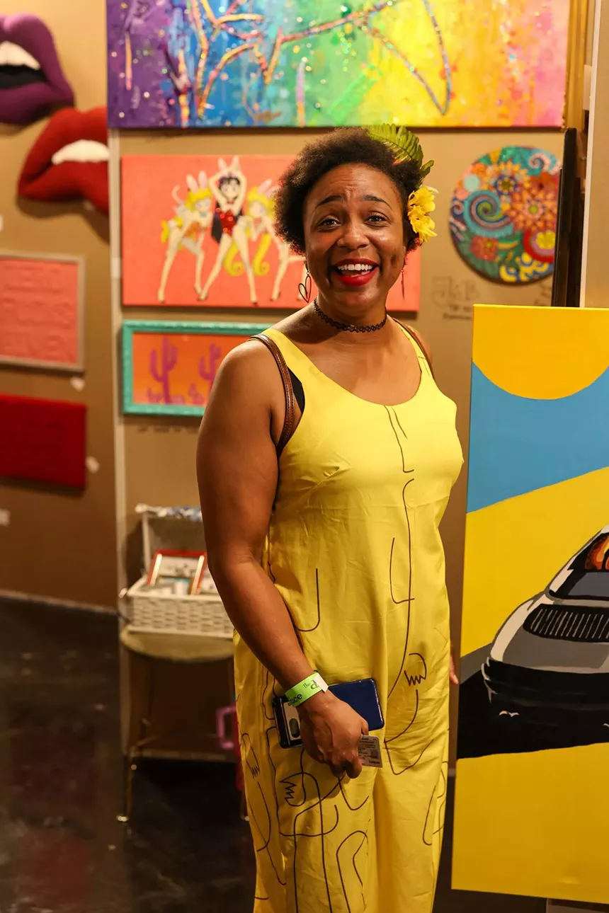 A Black woman in a yellow dress.