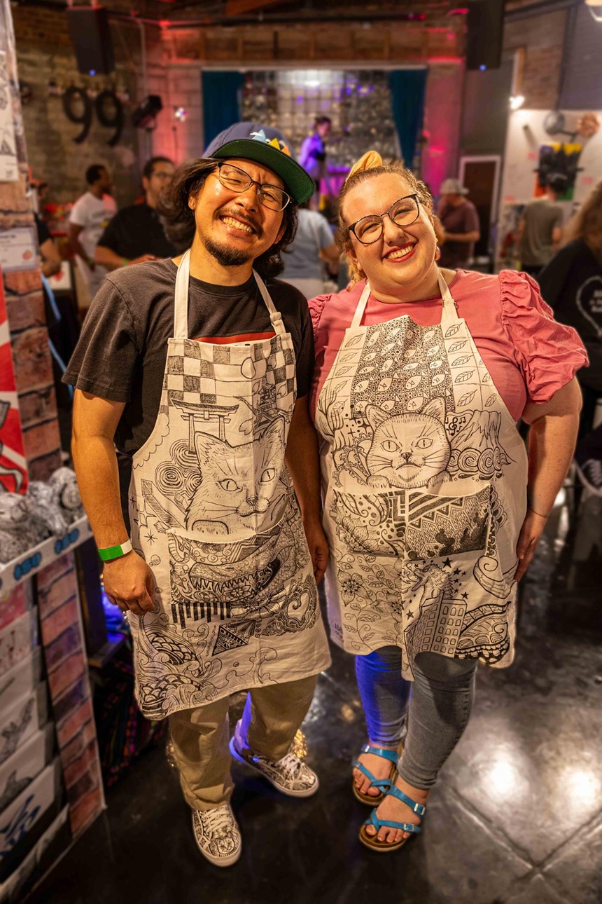 A man and a woman in matching aprons.