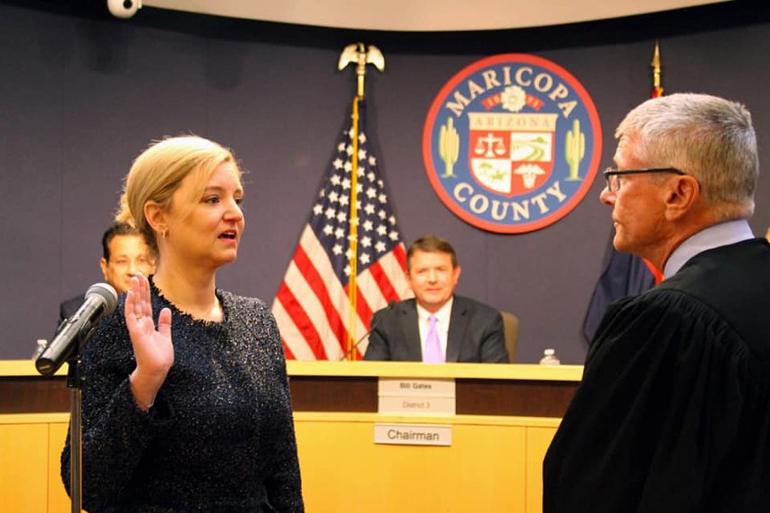 Allister Adel raises a right hand in front of a judge in a courtroom