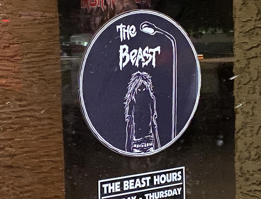 A black circular logo with a shadowy figure on a glass door.