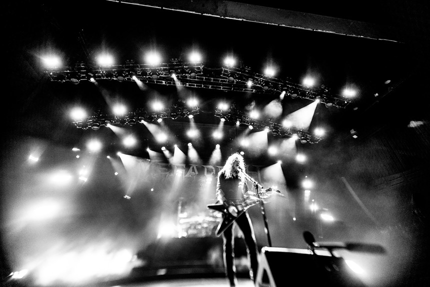 A man plays guitar onstage.