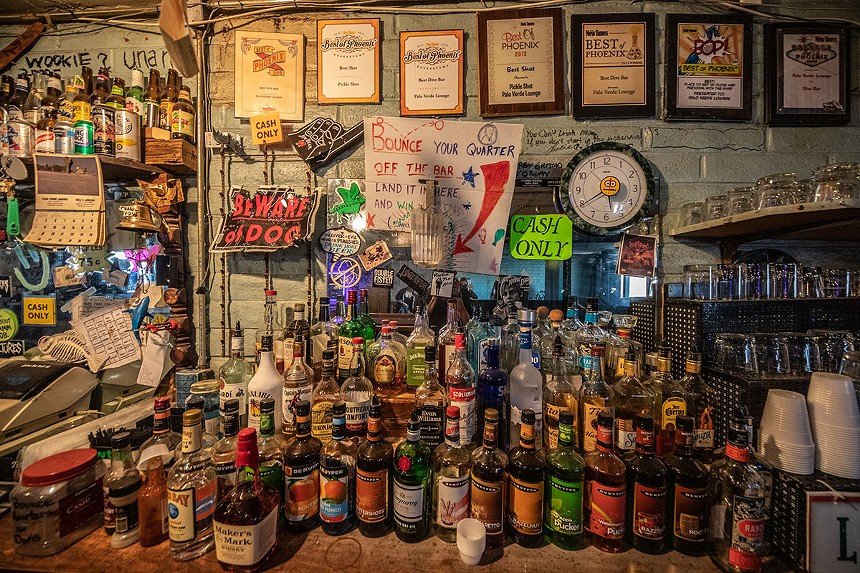 The wall of a bar filled with bottles of alcohol.