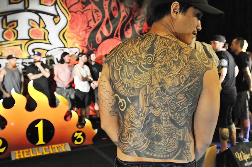 A male with large back tattoo.