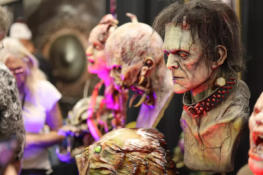 Monster masks for sale at a convention.
