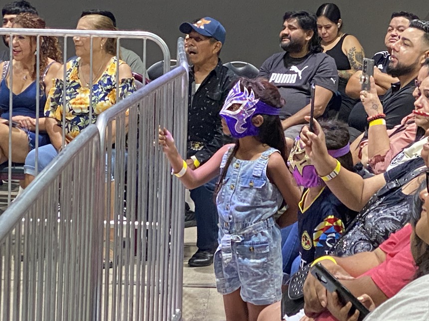 A child in a purple wrestling mask.