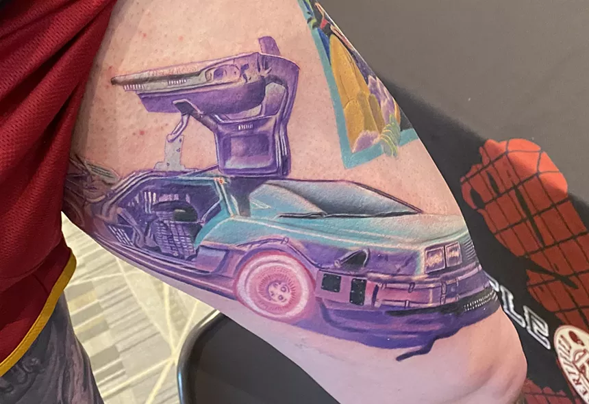 A leg tattoo with the DeLorean from the "Back to the Future."