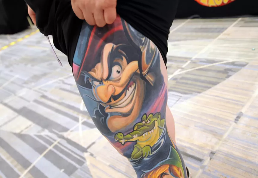 A leg tattoo of characters from "Peter Pan."