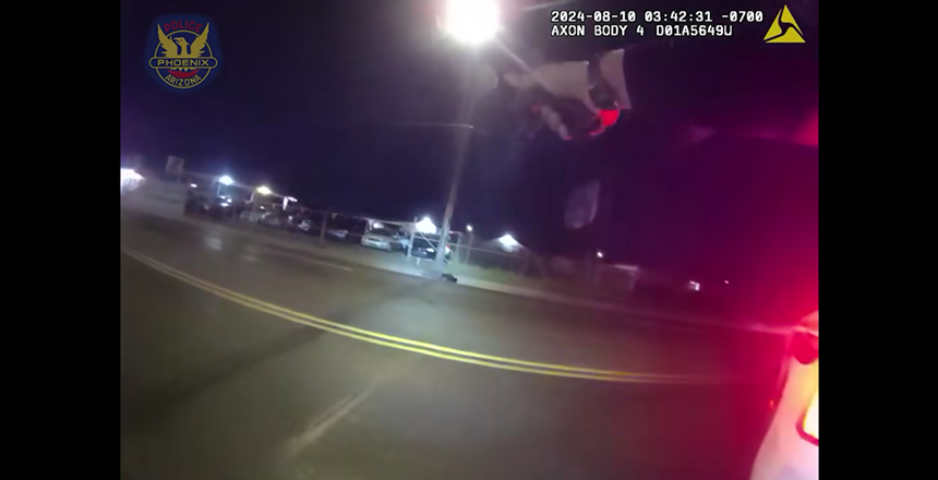 body-cam footage showing hands pointing a gun at a distance lifeless body on the sidewalk