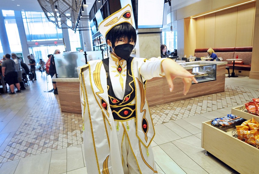 A person in costume standing in a lobby.