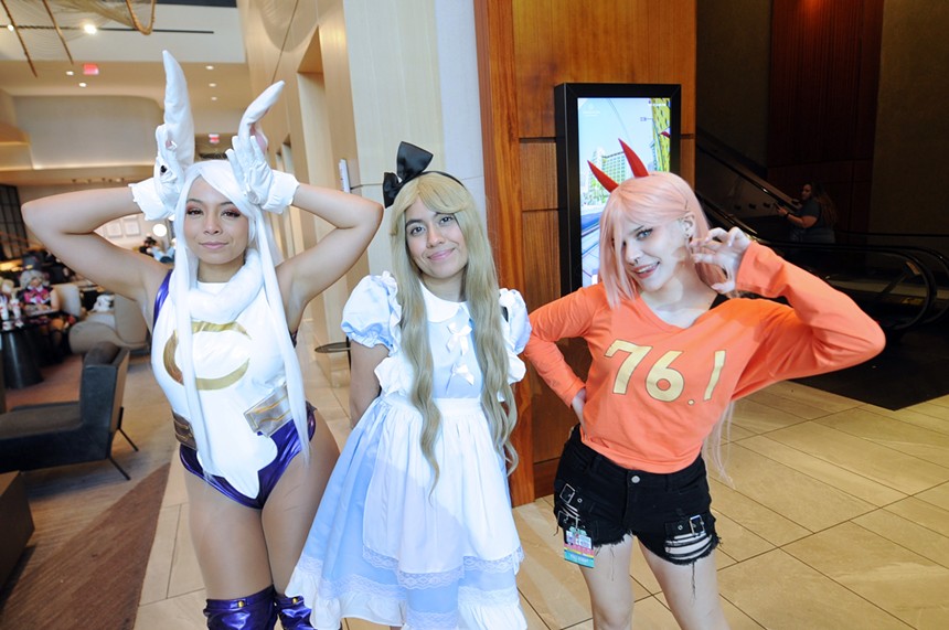 Three female friends wearing costumes.