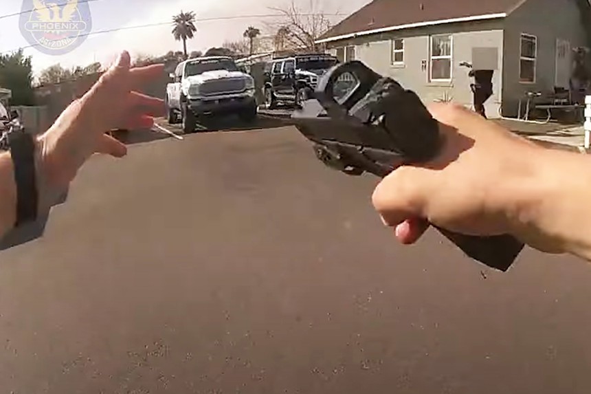 a still from a police body-cam showing a hand pointing a gun